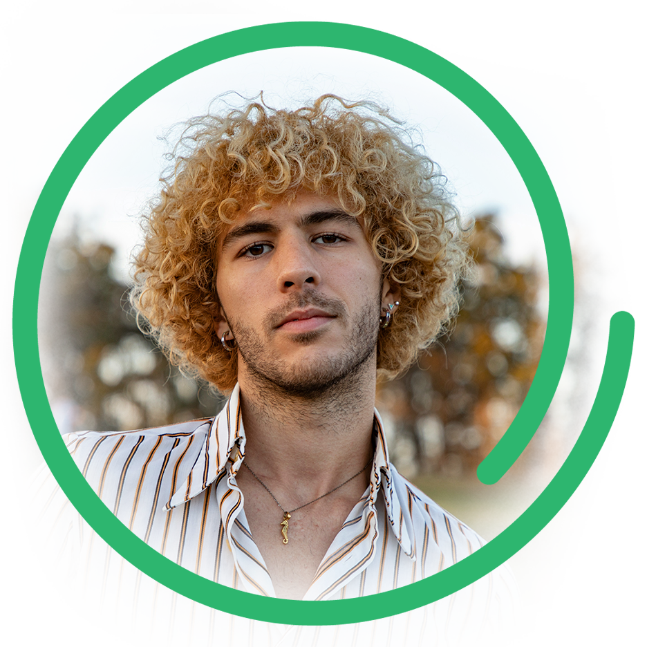 a photo of a young man with curly, dyed blond hair